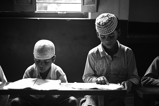 child reading book varanasi uttar pradesh India Asia