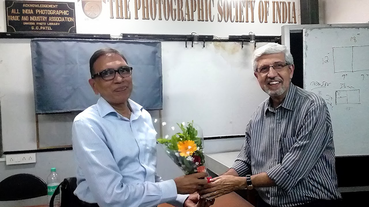 Aspi Patel presenting bouquet to Jagdish Agarwal after taking photography class at The Photographic Society of India. 